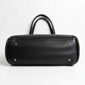 Black leather handbag with silver studs on a white background