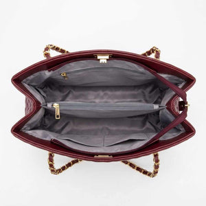 Open red handbag with gold chain detail on a white background