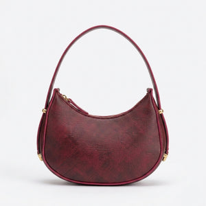Red handbag with gold accents on a white background