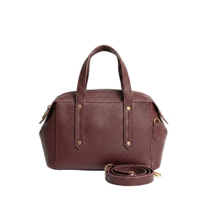 Brown leather handbag with a detachable strap on a white background