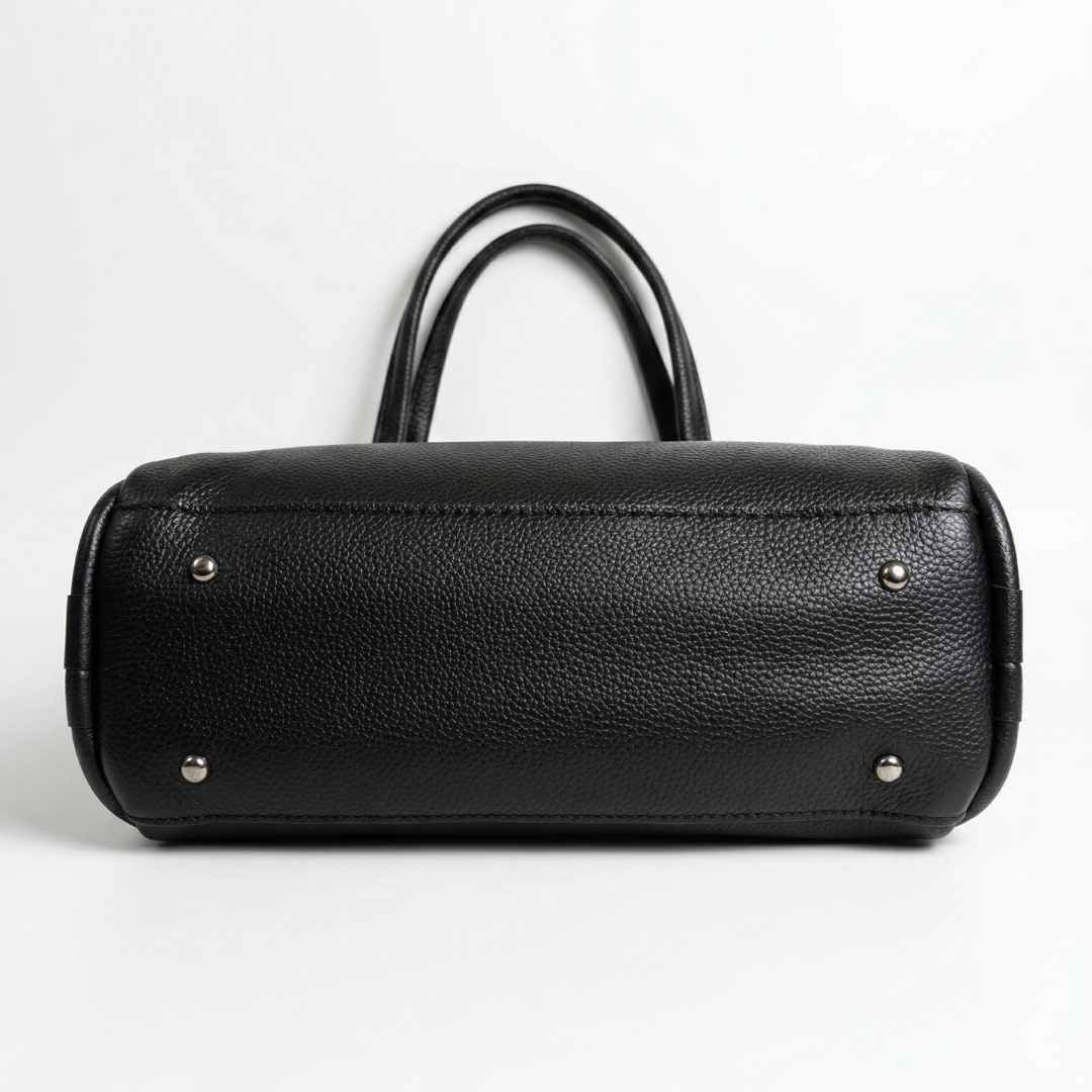 Black leather handbag with silver studs on a white background