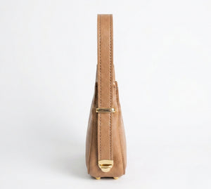 Tan handbag with a gold clasp on a white background