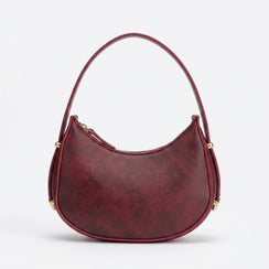 Red handbag with gold accents on a white background