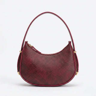 Red handbag with gold accents on a white background