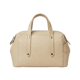 Beige handbag with silver studs on a light gray background
